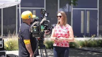 Janna Tolla talking to local news interview about the Memorial Day Ceremony